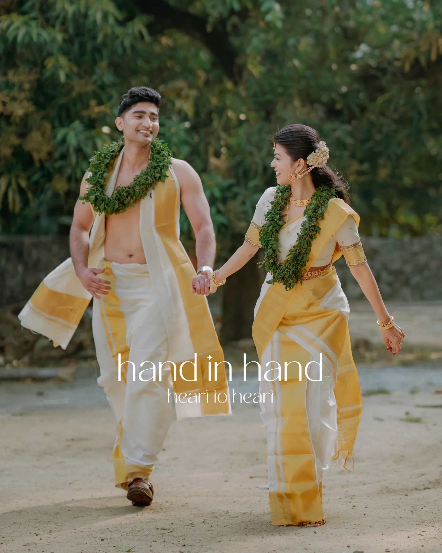 A couple walking hand in hand in traditional Kerala wedding attire